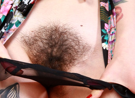 Enchanting Anni flaunts her tattoos and her big thick bush - 4 of 16