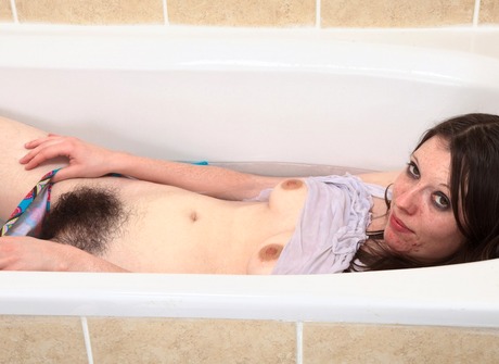 Young brunette Laufy displays her giant bush in the bathtub - 7 of 16