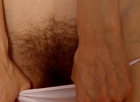 Naughty nurse Alice fondles her fluffy muff in the floor