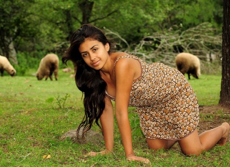 Beautiful exotic babe Ambar shares her hairy pussy outdoors