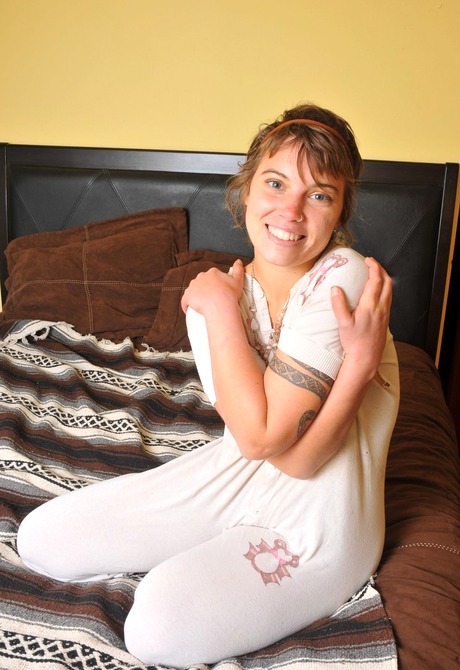 Pierced and tattooed amateur showing her hairy pussy