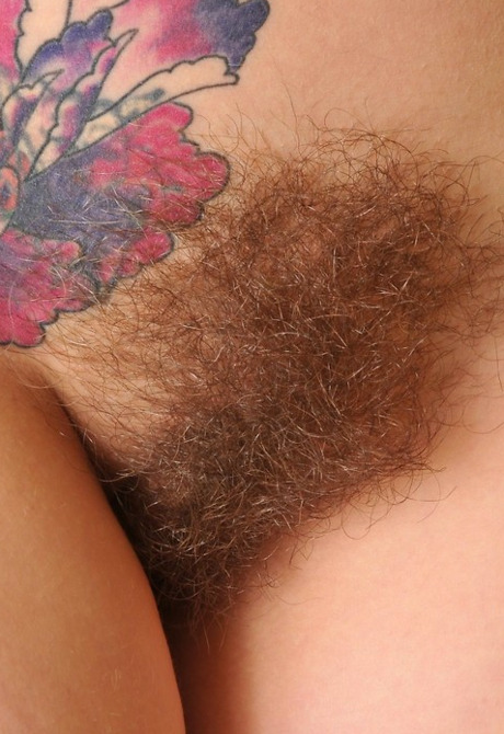 Pierced and tattooed amateur showing her hairy pussy