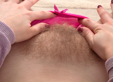 Aston strips on the couch to share her lovely bearded clam