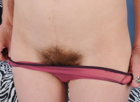 Hairy redhead Brandi Dandi spreading furry snatch in bed - 8 of 16