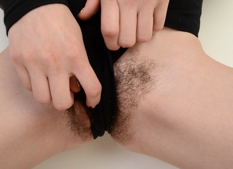 Foxy redhead Emma reveals her round ass and fluffy snatch - 4 of 16