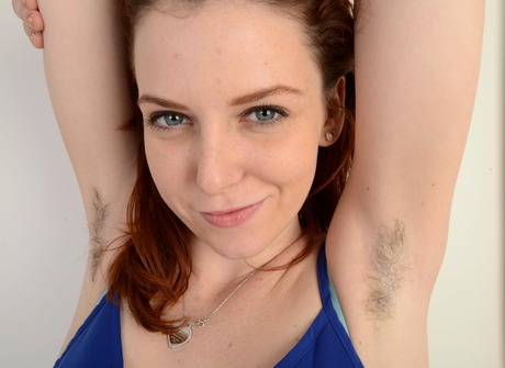 Foxy redhead Emma gets horny and fingers her hairy pussy - 2 of 16