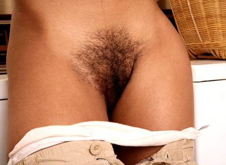 Black beauty Karmalita gets naked and shows her kinky bush - 9 of 15