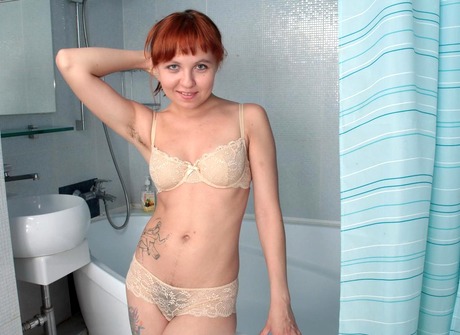 Flirty redhead Lexie strips naked to shower her shaggy muff