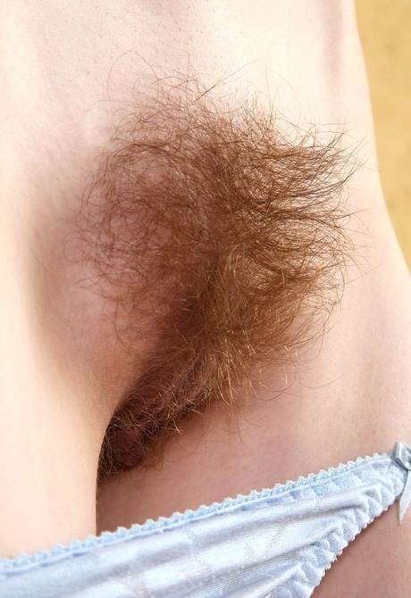 Slender Nika lifts up her dress to share her unshaved pussy - 8 of 16