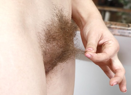 Pretty brunette Niki tempts and teases with her shaggy pussy - 12 of 16