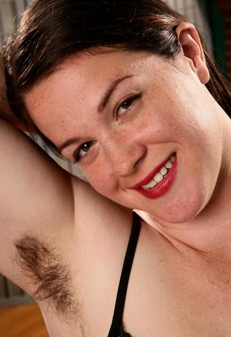 Chubby pale Paulette displays her shaggy crotch on the sofa