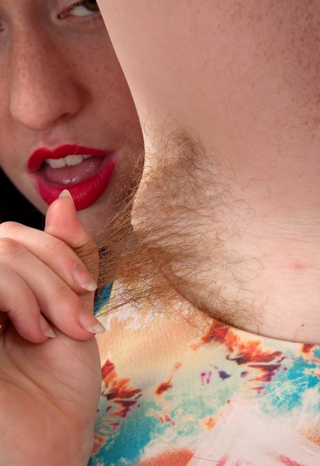 Playful redhead Rosie licks her fuzzy pits and spreads bush