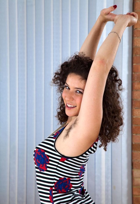 Curly haired cutie Sativa shows her furry pits and snatch