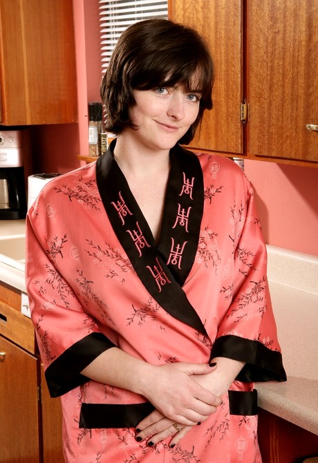 Snow gets horny in the kitchen and shows off her furry bush