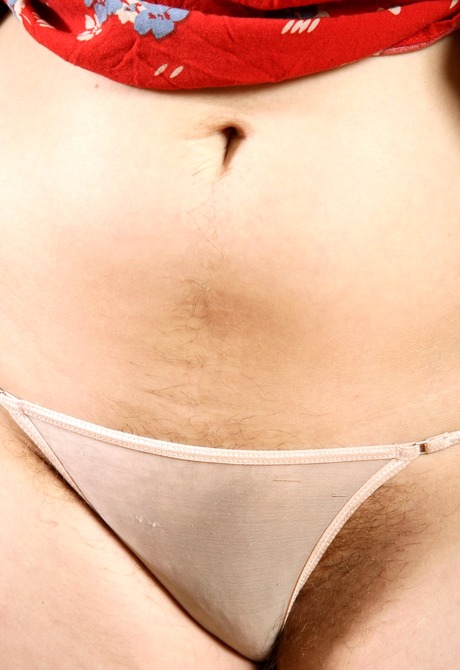 Curvy pale Sylvia teases with her fluffy muff on the couch - 3 of 16