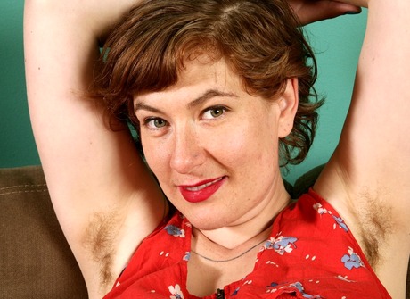 Curvy pale Sylvia teases with her fluffy muff on the couch - 5 of 16