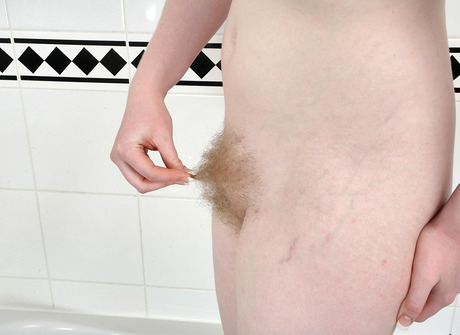 Chubby pale blonde Satine spreading hairy pussy in bathtub - 6 of 16