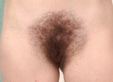 Anna May displays her petite figure and hairy pussy on the couch - 14 of 16