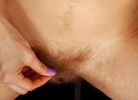 Hairy redhead Melina stripping and showing furry muff - 11 of 16