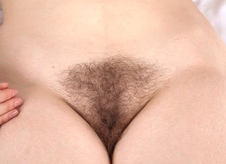 Chubby hairy teen Kady spreading unshaved muff in bed