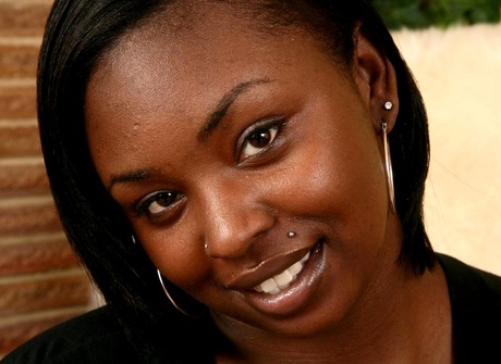 Thick ebony Chocolate reveals big tits and spreads hairy pussy for closeup
