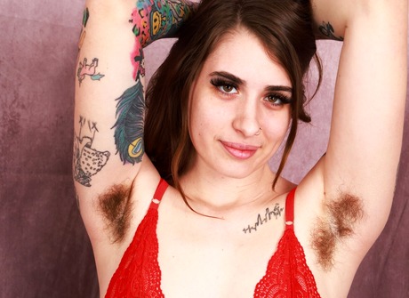 Tattooed cutie Pearl Sage revealing hairy pussy and armpits