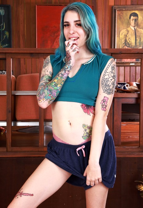 Pearl Sage takes off her clothes exhibiting her hairy armpits and tattooed body