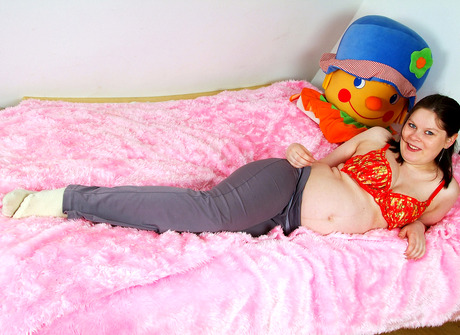 pregnant lady Tina takes off her clothes on the bed and spreads pussy - 4 of 16