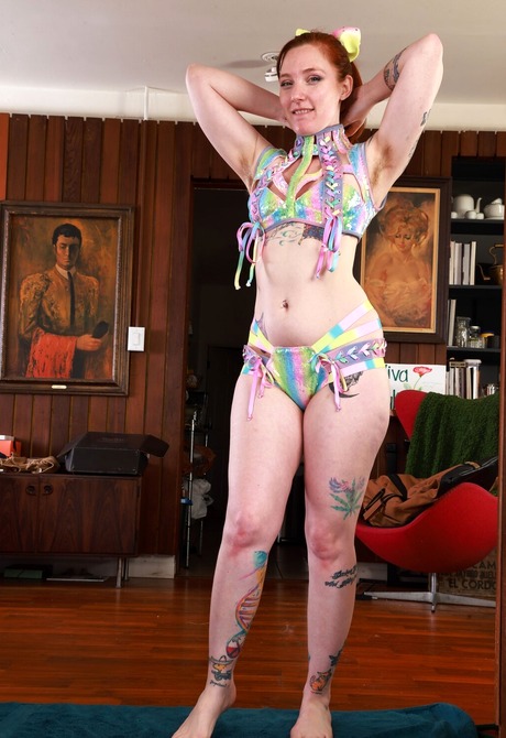 Redhead with tattoos Kitty Strange reveals hairy pussy and small tits - 3 of 16