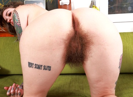 Brunette babe with tattoos Pearl Sage reveals extremely hairy pussy after stripping - 15 of 16