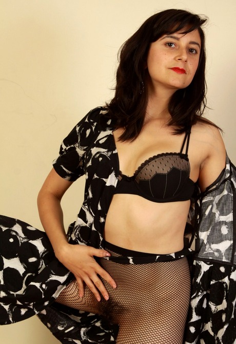 Altaira seductively gets naked in the bedroom exposing her hairy pussy - 6 of 16