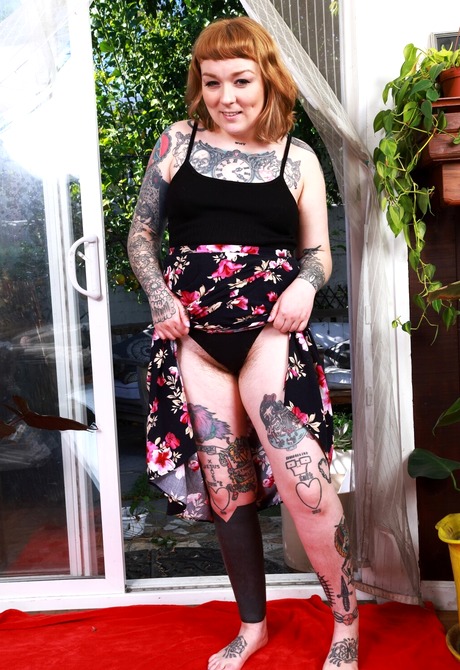 Tattooed redhead Felicia Fisher teases with hairy armpits and nice ass after stripping - 3 of 16