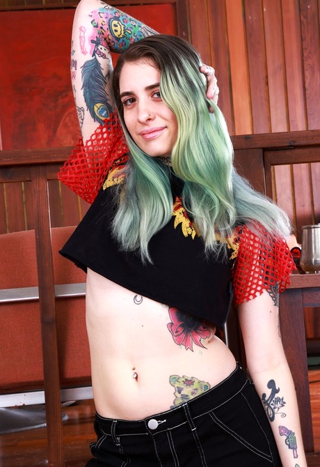 Stunning babe with green hair Pearl Sage strips to reveal hairy armpits, and hairy nipples - 2 of 16