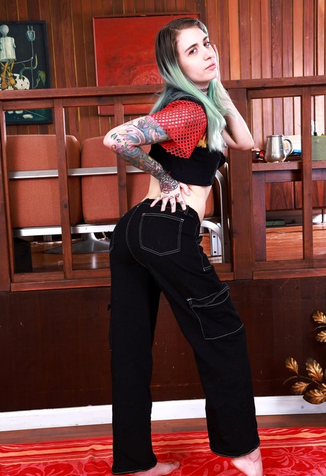 Stunning babe with green hair Pearl Sage strips to reveal hairy armpits, and hairy nipples - 3 of 16